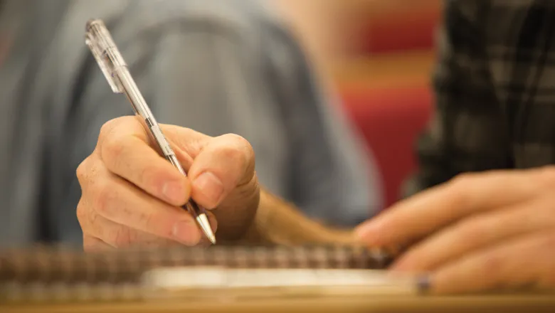A close-up of a hand holding a pen.